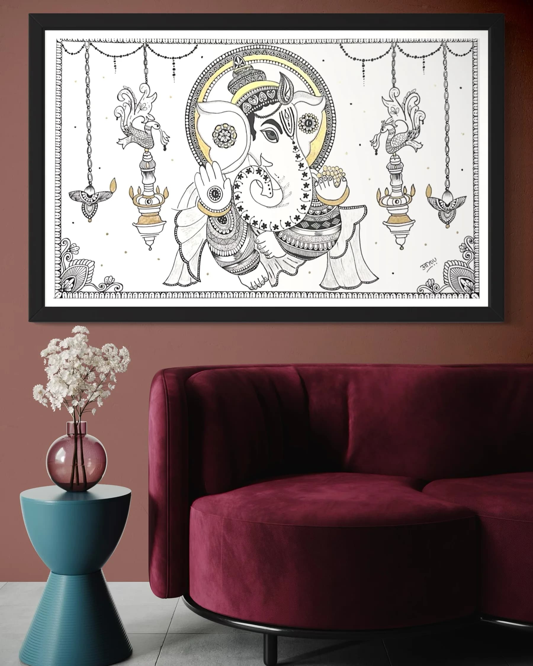 Ganesha in black line work with a gold halo, one hand raised in blessing and one holding a bowl of sweets, between hanging peacock lamps