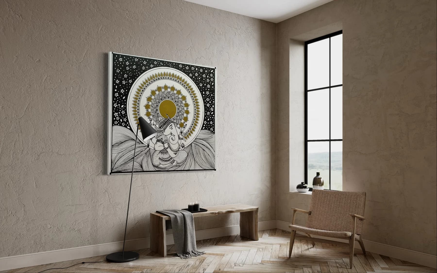 Ganesha in black and white line work beneath a gold mandala halo and a starry black sky, framed on a textured wall