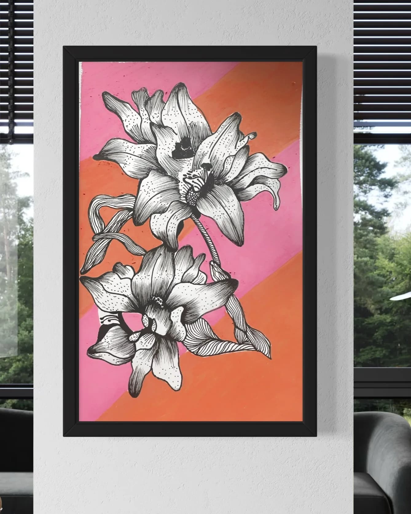 Black and white lilies drawn over a pink and orange background, in a black frame