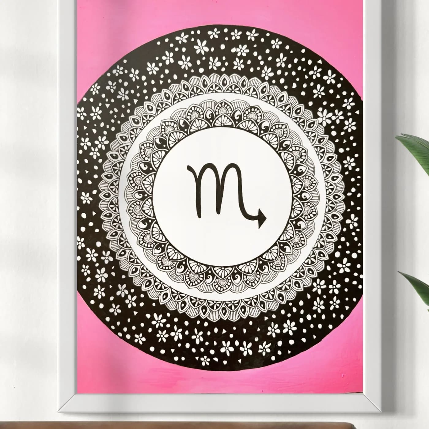 Scorpio sign in a dotted black mandala on a pink background