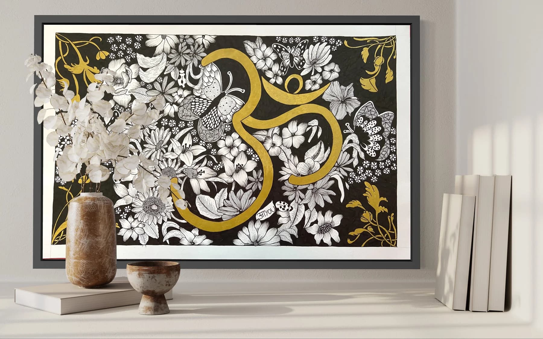 A gold Om symbol among hand-drawn white flowers on a black background, in a wide black frame